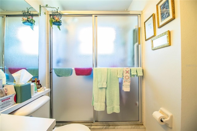 bathroom with a stall shower, plenty of natural light, and toilet