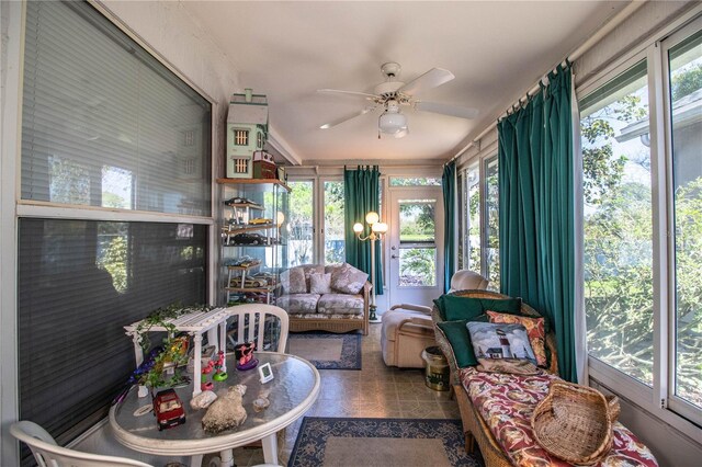 sunroom featuring ceiling fan