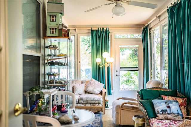 sunroom featuring a wealth of natural light and a ceiling fan