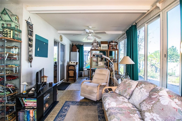 living room featuring plenty of natural light, beam ceiling, and a ceiling fan