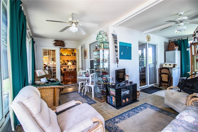 living room with ceiling fan and beamed ceiling