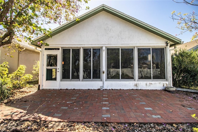 back of house with a patio and stucco siding