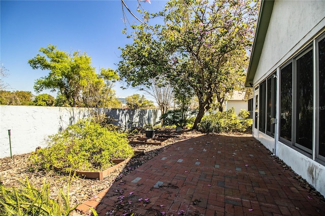 view of patio / terrace with a garden and a fenced backyard