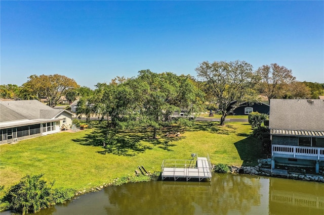 exterior space featuring a yard and a water view