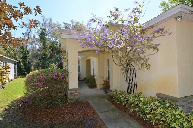 exterior space with a lawn and stucco siding