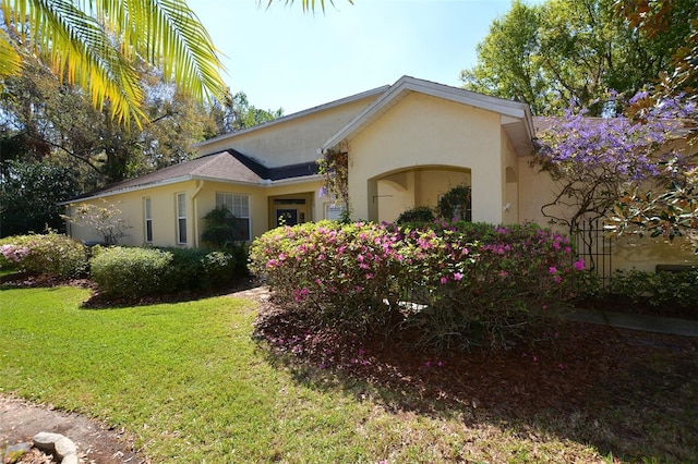 view of side of home featuring a yard and stucco siding