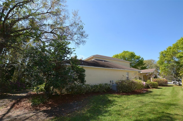 view of home's exterior featuring a yard and stucco siding