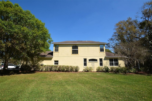 exterior space with a lawn and stucco siding