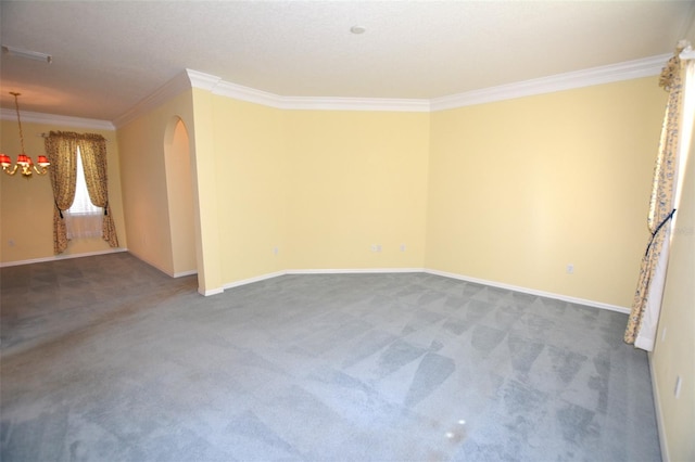 empty room with carpet floors, arched walkways, ornamental molding, and baseboards