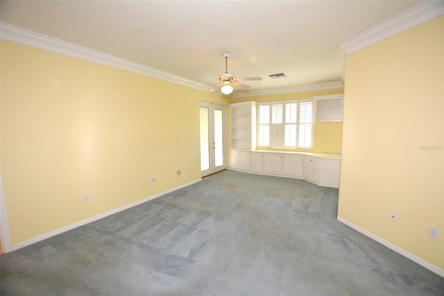 spare room with baseboards, visible vents, light colored carpet, and ornamental molding