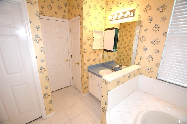 bathroom with tile patterned flooring, vanity, baseboards, and wallpapered walls