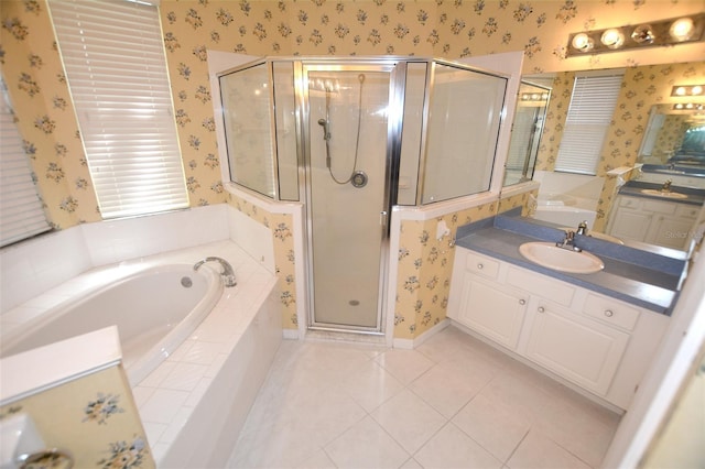 full bathroom featuring a garden tub, vanity, a shower stall, tile patterned floors, and wallpapered walls