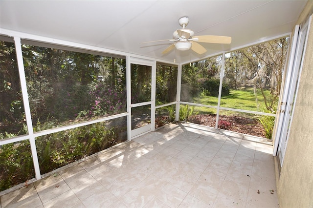 unfurnished sunroom featuring ceiling fan