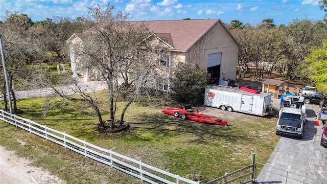 view of front of house featuring a fenced front yard, a front yard, and stucco siding