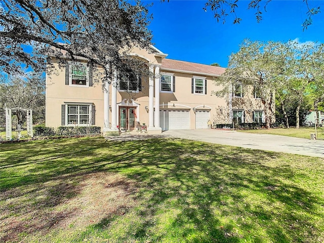 11175 Hyde St, Weeki Wachee, FL 34614 - greek revival house with stucco siding, an attached garage, concrete driveway, french doors, and a front lawn