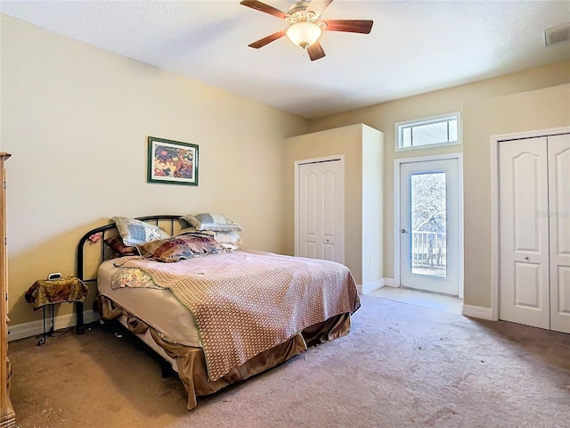 11175 Hyde St, Weeki Wachee, FL 34614 - carpeted bedroom featuring multiple closets, baseboards, access to outside, and a ceiling fan