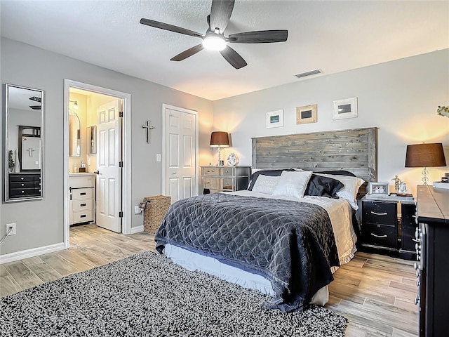 bedroom featuring a ceiling fan, baseboards, visible vents, and light wood finished floors