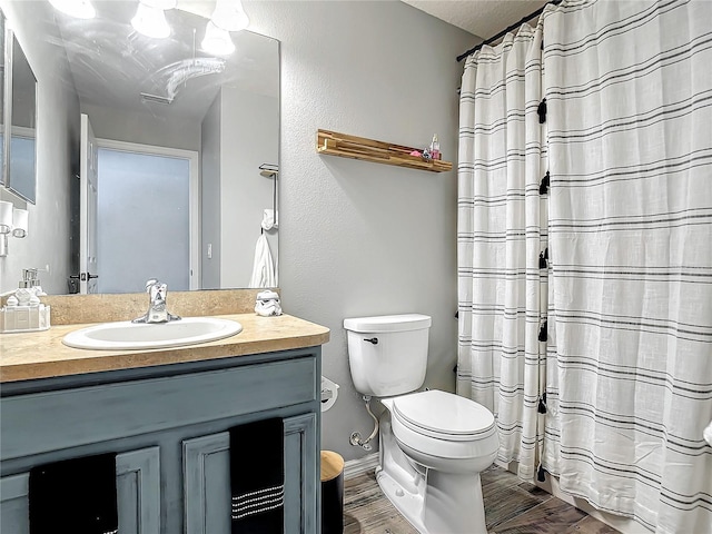 full bathroom with toilet, vanity, a shower with shower curtain, and wood finished floors