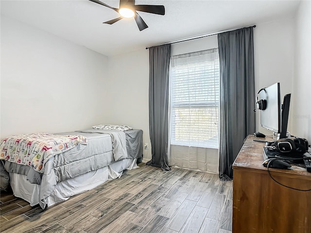 bedroom with ceiling fan and wood finish floors