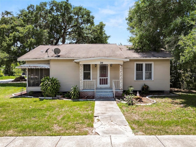 view of front of property with a front yard and covered porch