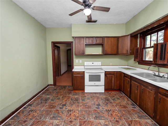 kitchen with open shelves, light countertops, electric range, a sink, and baseboards