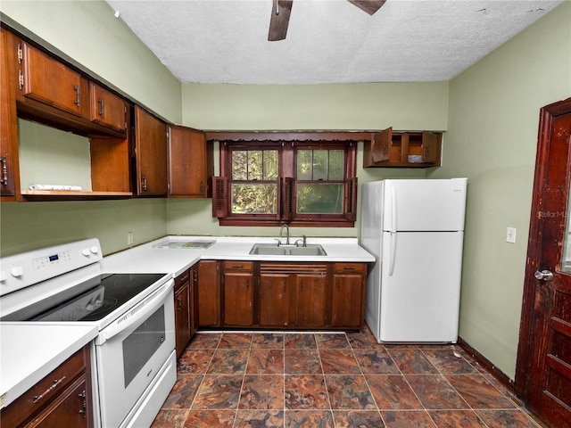 kitchen featuring light countertops, a ceiling fan, a sink, a textured ceiling, and white appliances