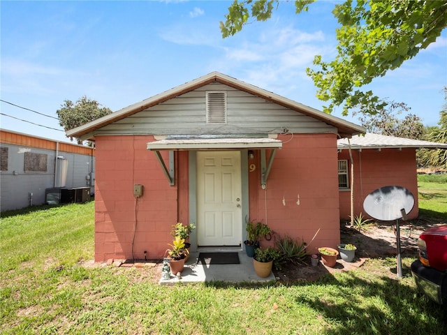 exterior space featuring a front yard and concrete block siding