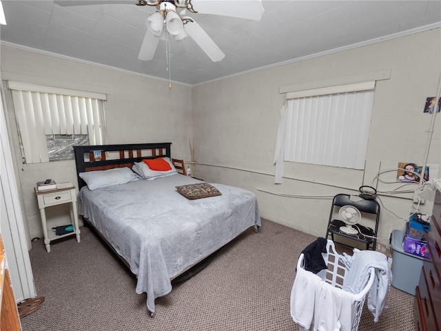 carpeted bedroom with ornamental molding and a ceiling fan