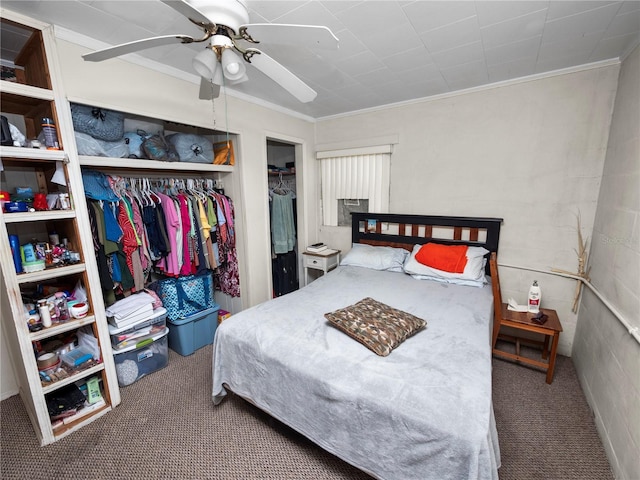 bedroom with crown molding, a closet, a ceiling fan, and carpet flooring