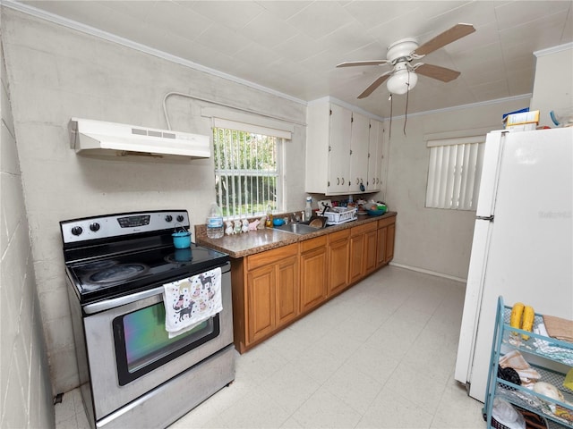 kitchen with ornamental molding, light floors, freestanding refrigerator, stainless steel electric stove, and under cabinet range hood