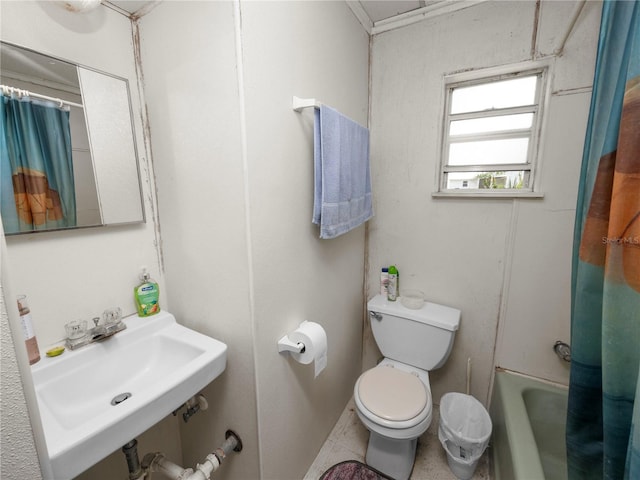 bathroom with a sink, toilet, and shower / bathtub combination with curtain