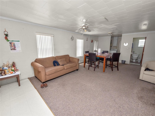 living room with ceiling fan and crown molding