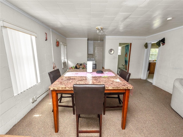 carpeted dining area featuring ornamental molding