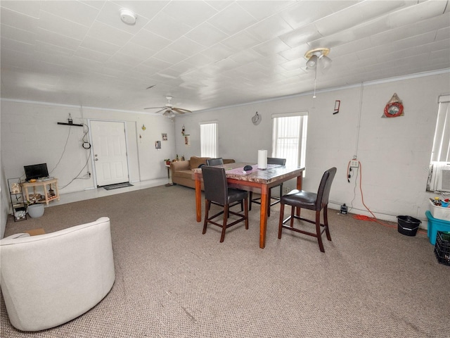 dining area with ceiling fan, ornamental molding, cooling unit, and light colored carpet