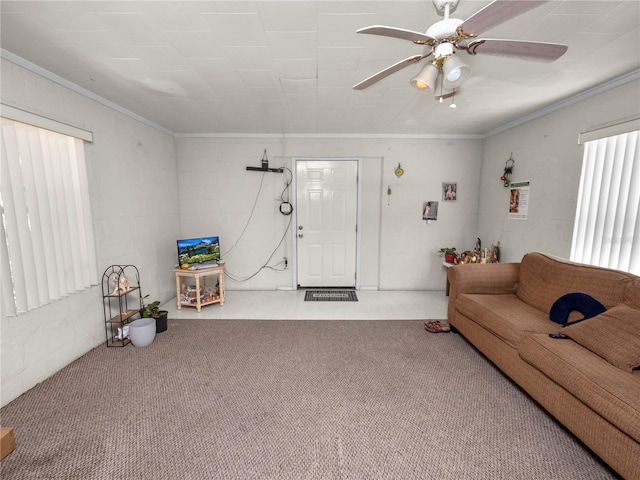 carpeted living area featuring a ceiling fan and crown molding