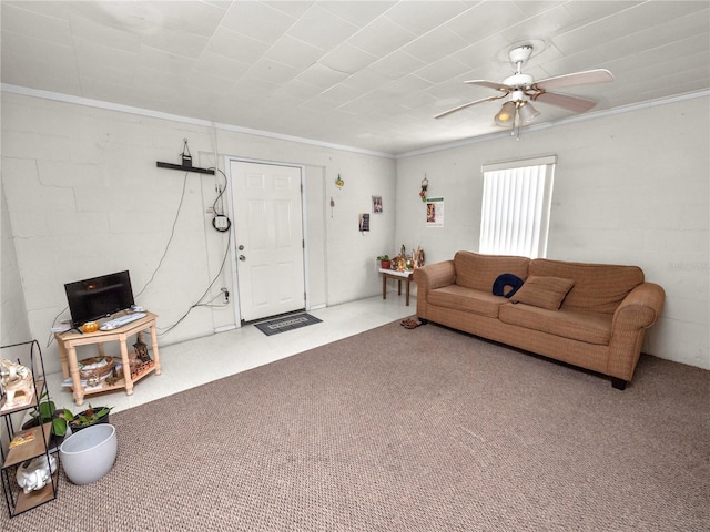 living area featuring a ceiling fan, ornamental molding, and carpet flooring