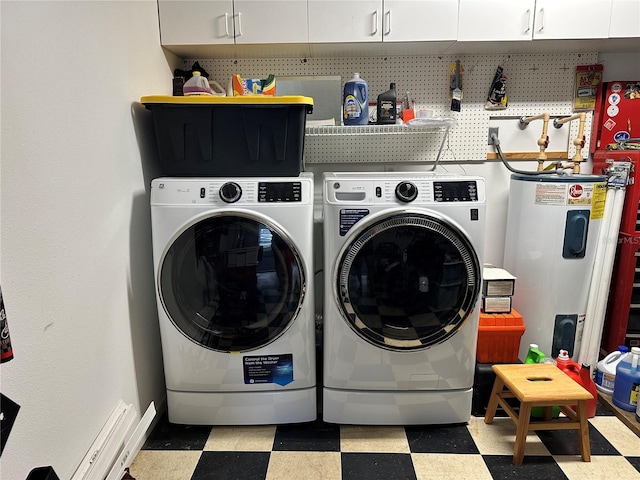 washroom with laundry area, washing machine and dryer, water heater, and tile patterned floors