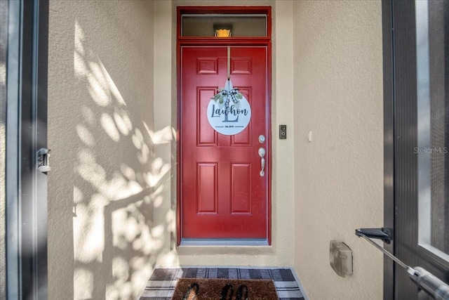 entrance to property with stucco siding