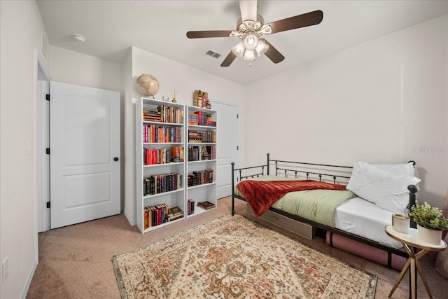 carpeted bedroom with ceiling fan, visible vents, and baseboards