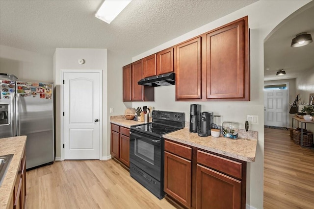 kitchen featuring black electric range, stainless steel refrigerator with ice dispenser, light wood finished floors, light countertops, and under cabinet range hood