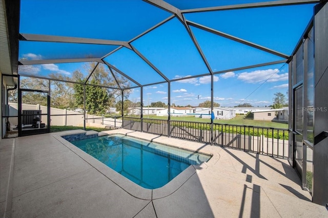 view of swimming pool with a patio area, a lanai, a fenced in pool, and fence