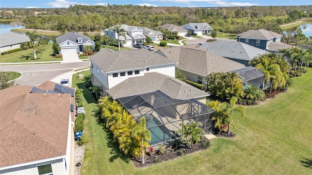 drone / aerial view featuring a water view and a residential view