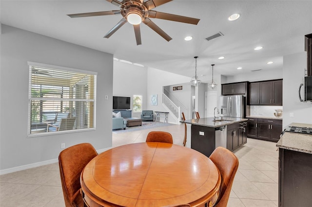 dining area with light tile patterned floors, visible vents, ceiling fan, stairway, and recessed lighting