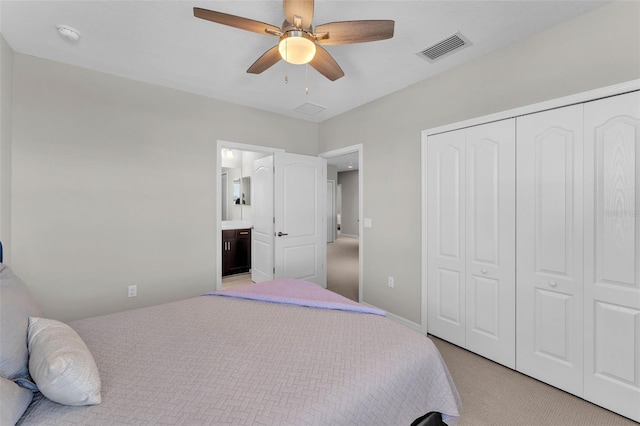 bedroom featuring visible vents, a ceiling fan, light colored carpet, ensuite bathroom, and a closet