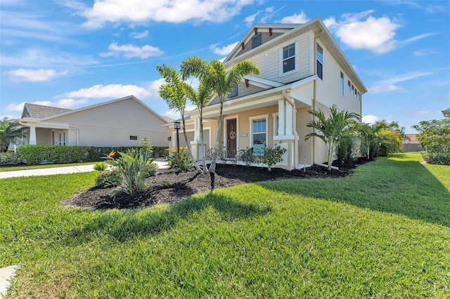 view of front of house with stucco siding and a front yard