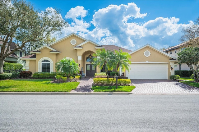 view of front of home with a garage, decorative driveway, and stucco siding