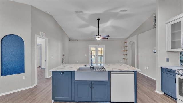 kitchen featuring lofted ceiling, light wood-style flooring, and visible vents