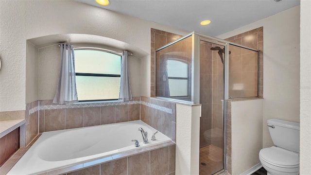 full bathroom with a garden tub, a shower stall, and toilet