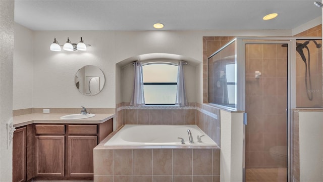 bathroom with a shower stall, vanity, and a bath