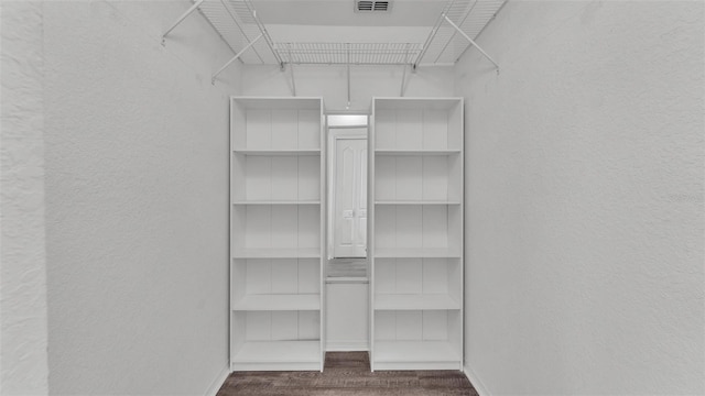 spacious closet featuring wood finished floors